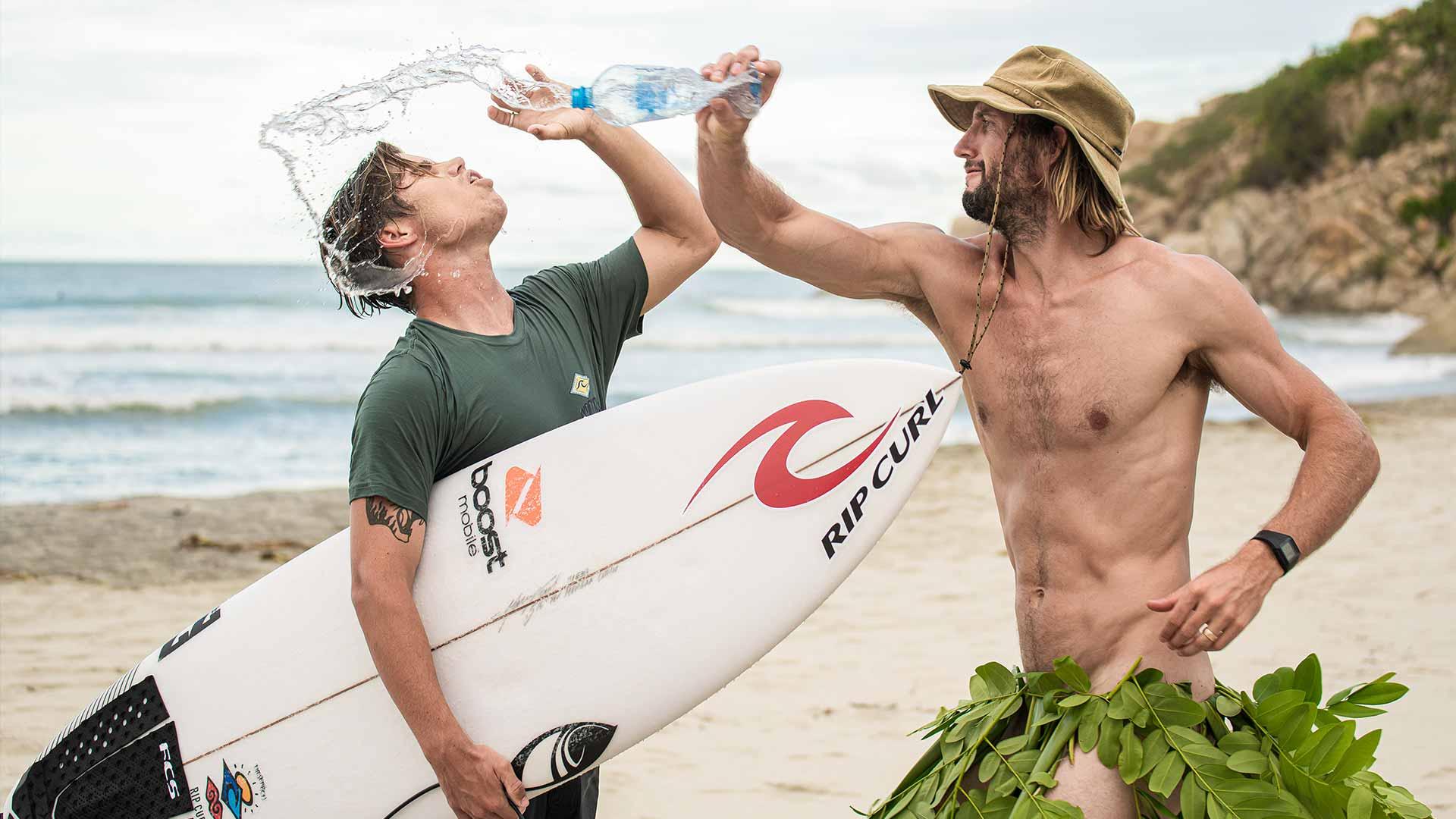 Owen Collects Plastic Bottles Along A Beach In Mexico In A Grass Skirt